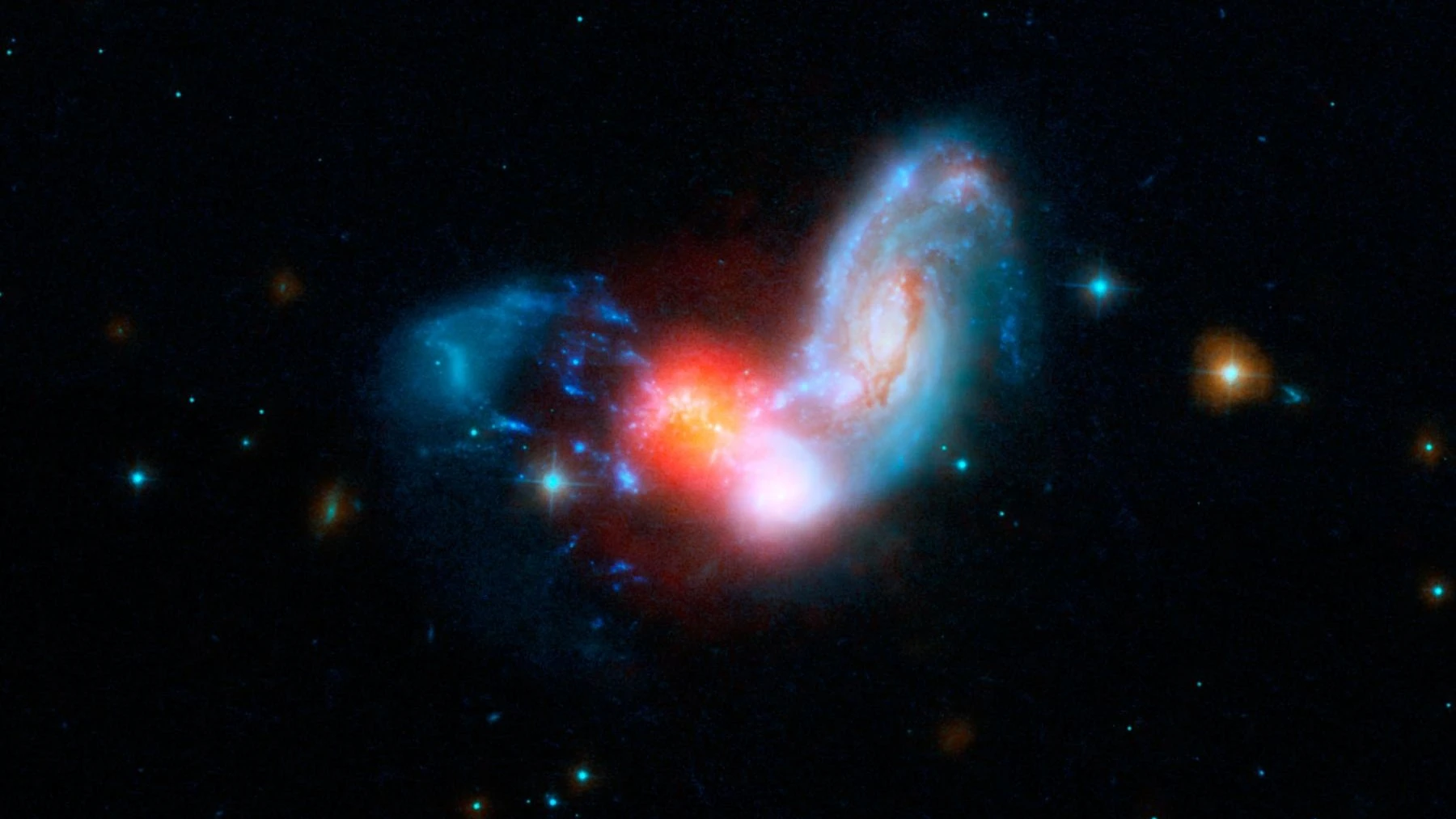 Две спиральные галактики сталкиваются, вызывая всплеск звездообразования